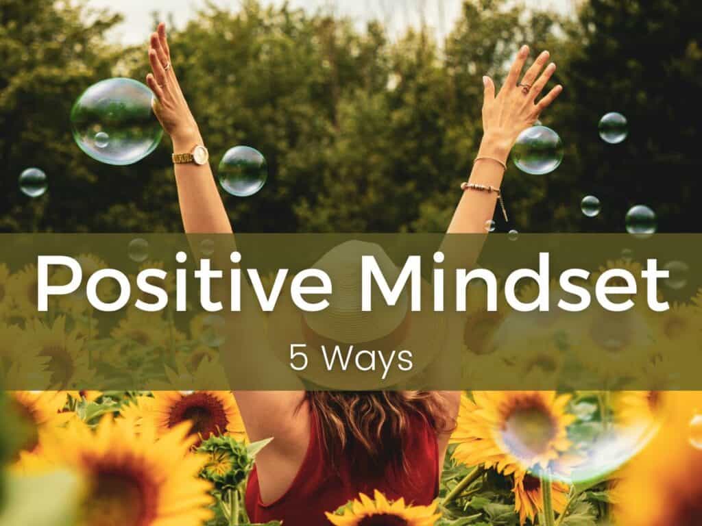 woman with arm upraised in a field of sunflowers with the words :positive mindset 5 ways" across the front
