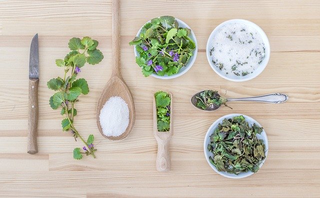 Herbs arranged on a countertop with fresh and dried varieties, 5 tips for growing your own herbs