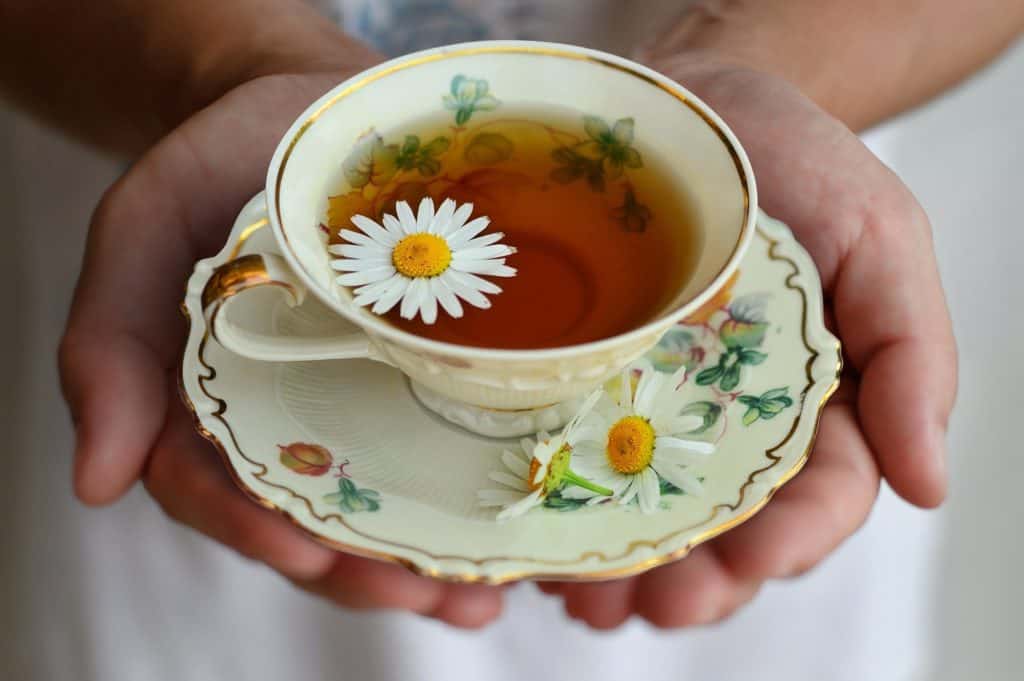 Chamomile tea with porcelain teacup.