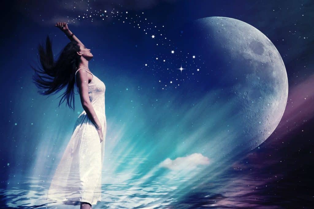 woman in ocean with a moon and stars overhead
