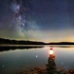 lantern on a lake shore with the milky way overhead to represent working with spirit guides