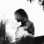 girl and tree in a fuzzy black and white shadowy image for shadow work