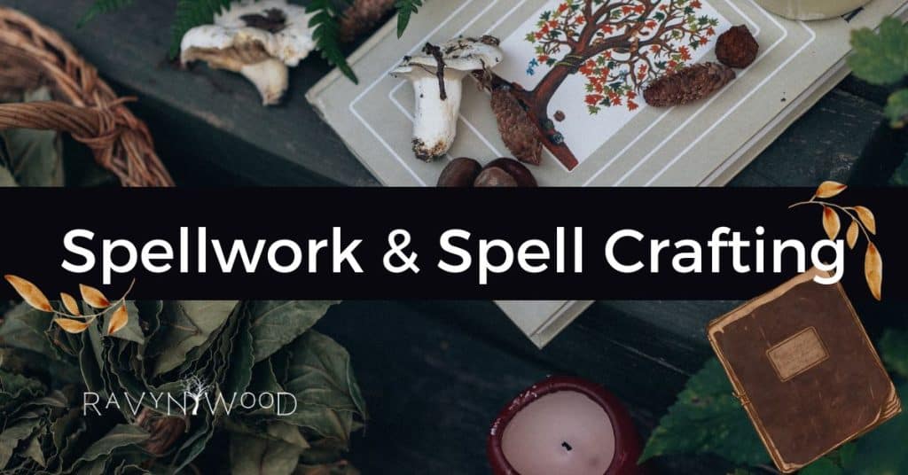 spellwork and spell crafting cover with an open book, fragments of spell ingredients laying on table top in background